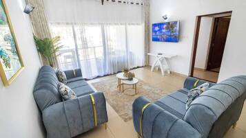 Deluxe Apartment | Living area | 24-inch Smart TV with digital channels