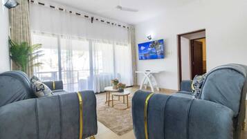 Deluxe Apartment | Living area | 24-inch Smart TV with digital channels