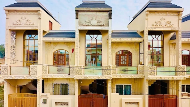 A multi-story building with ornate architectural details, including decorative columns and balconies. - Urbanaid Uniworld (Bara Banki)