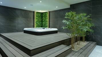 Relax in a serene spa area with a hot tub and vertical garden.