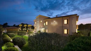 A modern hotel with a well-maintained garden and a clear view of the sky. - Malibu Grand Royale - Luxury Group Villa with Pool (Vir)