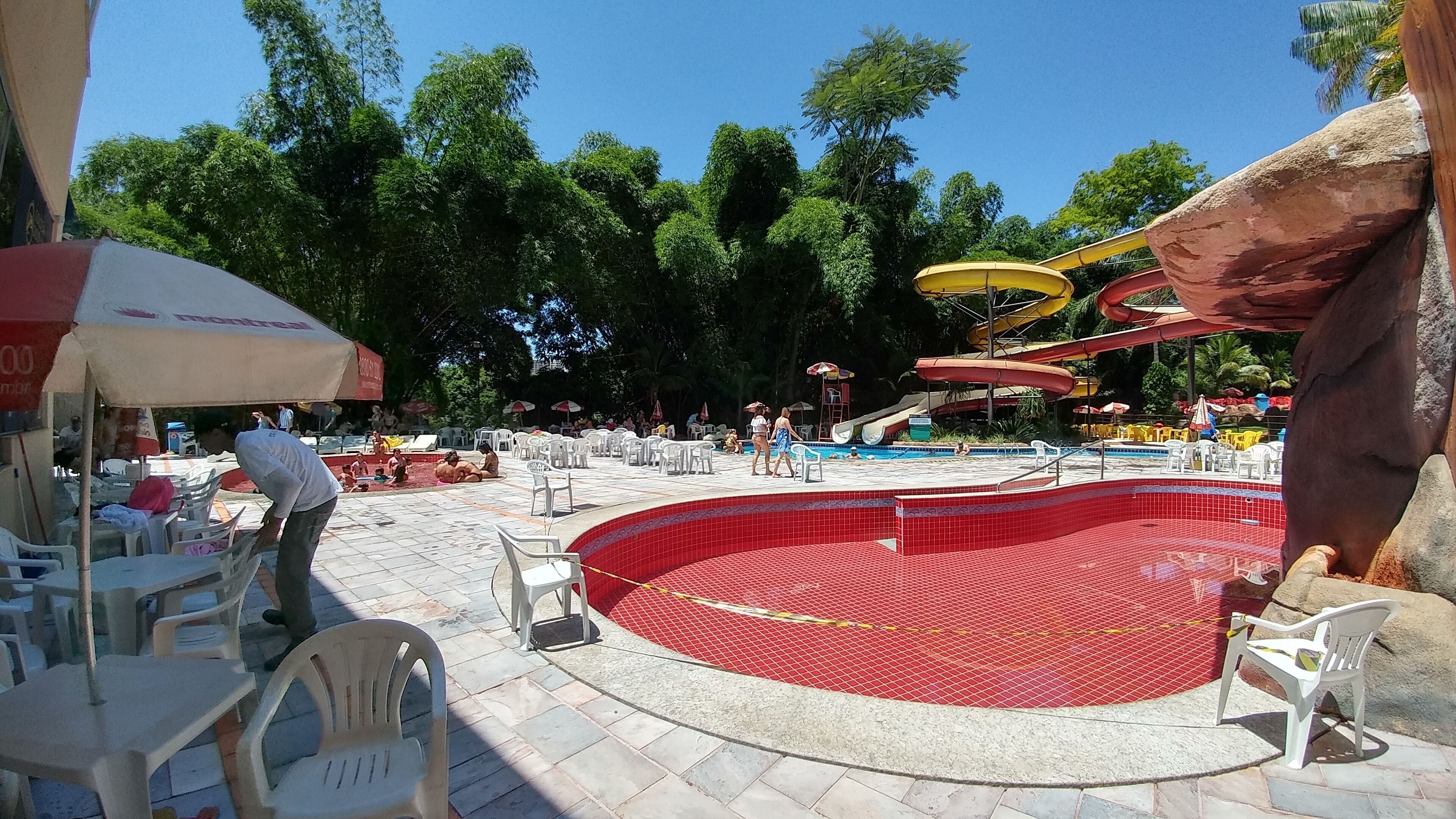 En vandpark med centralt poolområde, vandrutsjebaner og udendørs siddepladser.