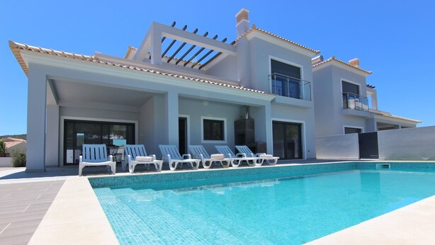 A modern two-story house with a swimming pool, outdoor seating, and a covered patio area. - Villa Goncinha - Private Pool & BBQ (Loulé)