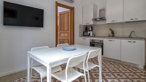 A compact kitchen with white cabinets, a microwave, and a coffee maker. - Casa Libeccio. Apartment in the center with A/C and free wi-fi. (Alghero)