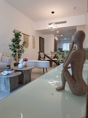 Deluxe Apartment, 2 Bedrooms, Pool View | Living area | Flat-screen TV - Coral Bay by DR Collection (Punta Cana)