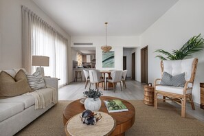 Deluxe Apartment, 2 Bedrooms, Pool View | Living area | Flat-screen TV - Coral Bay by DR Collection (Punta Cana)