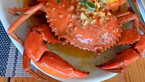 A plate of cooked crab with corn and vegetables. - 8hotel (Bantayan)