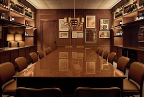 A conference room with a long table, chairs, and wall-mounted lamps. - GRAND MESS Clermont-Ferrand (Clermont-Ferrand)