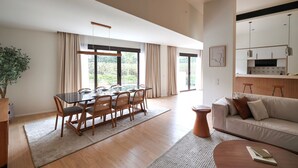 A spacious living area with a dining table, sofa, and kitchen area. - VESTA - Luxury APT - 3BR - La Mirada (New Cairo City)