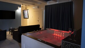 A modern living room with a heated floor, a flat-screen TV, a sofa, and a coffee table.
