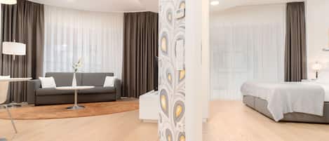 One - Bedroom Panorama Suite | Living area | 49-inch flat-screen TV with cable channels