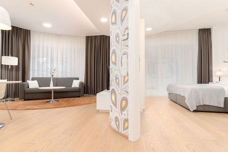 One - Bedroom Panorama Suite | Living area | 49-inch flat-screen TV with cable channels