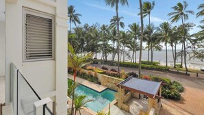Une piscine avec vue sur les palmiers et la plage.
