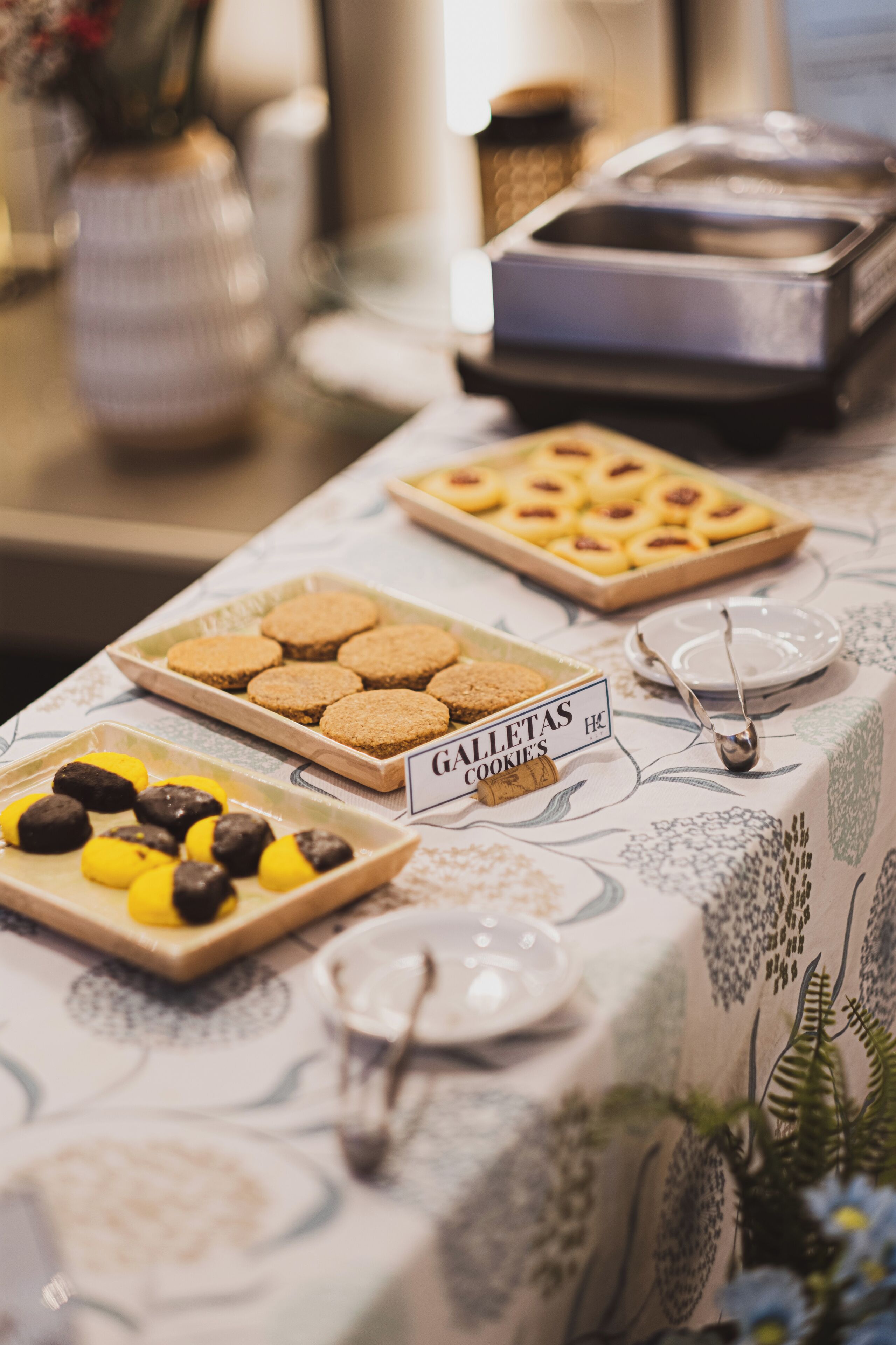 A buffet table with various cookies and pastries.