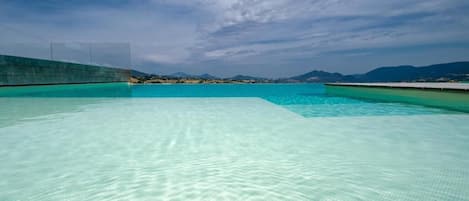 Seasonal outdoor pool, pool umbrellas, pool loungers