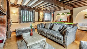 A spacious living room with a high ceiling, exposed wooden beams, a pool table, and a billiards table. - Beautiful 10 Bed Oak beamed Country House (Tibenham)