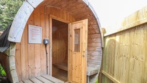 A wooden, dome-shaped structure with a wooden door and a small porch. - Beautiful 10 Bed Oak beamed Country House (Tibenham)