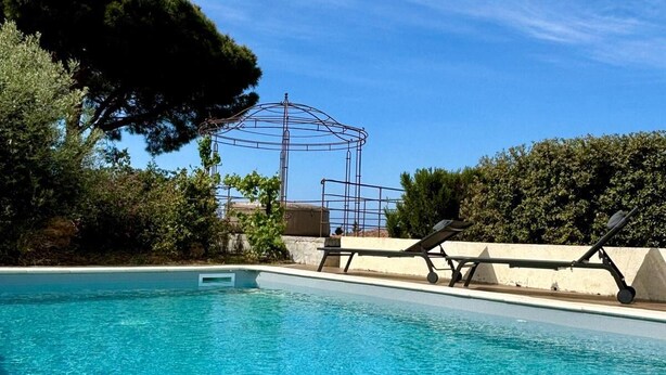 A clear blue pool with a diving board and lounge chairs. - Villa de 220 m2 Avec Piscine et vue mer à 5min des Plus Belles Plages de Balagne (L'ile-Rousse)
