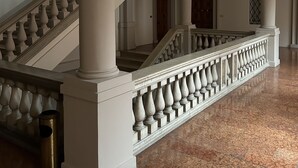 A grand staircase with ornate balustrades and marble flooring. - Charming residence inside a noble palace in the historic center (Rimini)