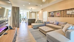 A modern living room with a sofa set, a coffee table, and a patterned rug.