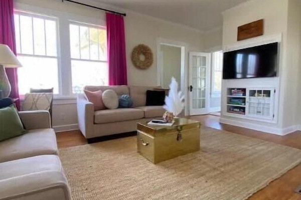 Large main floor living room connecting to the private work space & dining room.