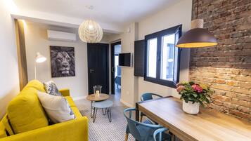 Apartment, City View | Living area | 32-inch Smart TV with cable channels