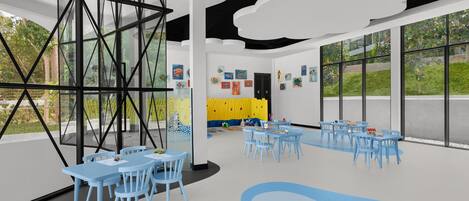 A modern children's playroom with blue furniture and artwork on the walls.