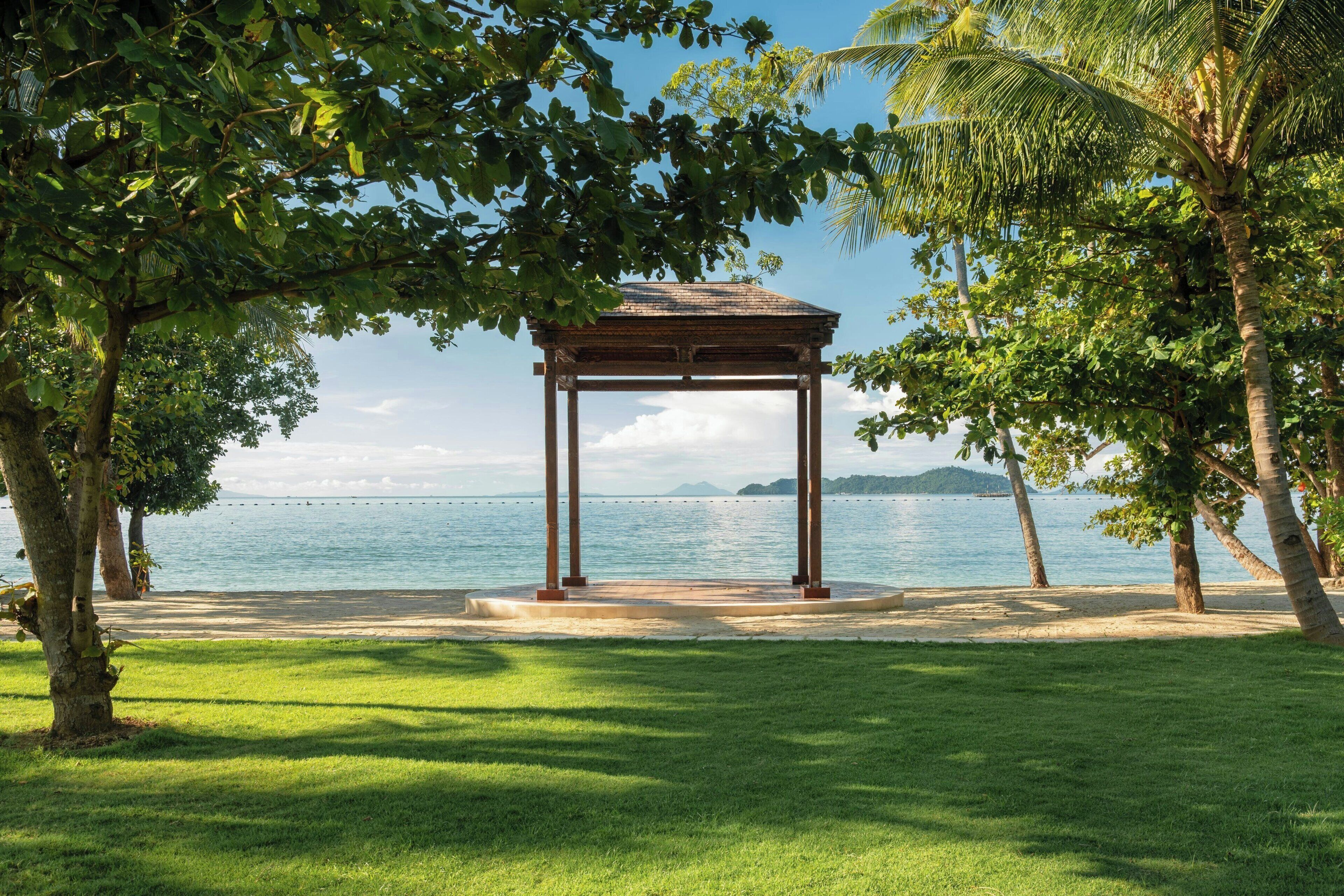 A gazebo with a view of the sea and a clear sky.