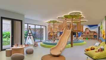 Un'area giochi per bambini con scivolo, strutture per arrampicarsi e sedute imbottite.