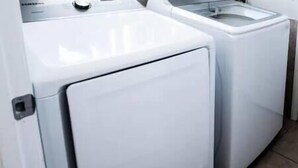A front view of a white washing machine and dryer side by side. - The Art House @ Walt Disney (Davenport)