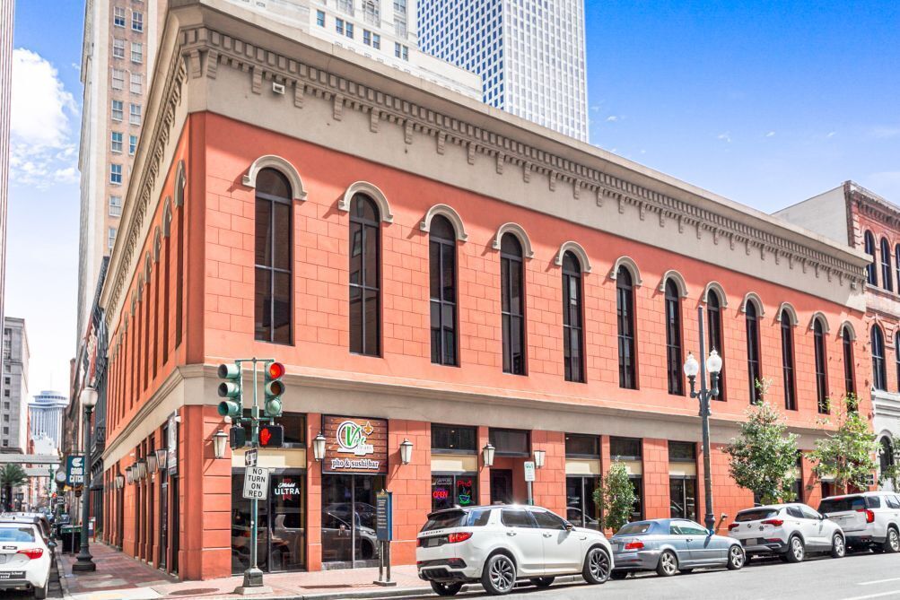 A red brick building with arched windows and a sign for 'Pho & Sushi'.