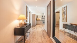 A modern hallway with a lamp, a console table, and a view into a kitchen area. - 7 Mares D12 in Punta Cana (Punta Cana)