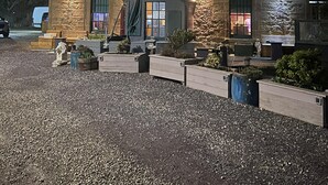 A stone building with a sign reading "INN" at night. - Captivating 2-bed Cottage in Kingsbarns (St. Andrews)