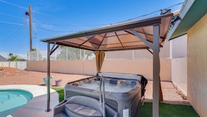 A hot tub under a shaded area with a pool nearby. - Cozy Lake Havasu City Home - Pool and Hot Tub (Lake Havasu City)
