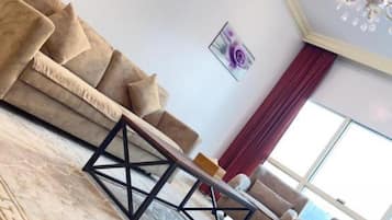 Panoramic Studio, Lake View | Living area | Flat-screen TV