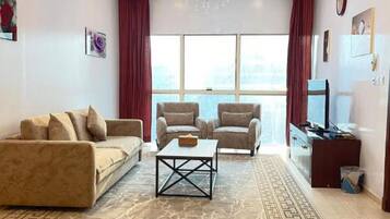 Panoramic Studio, Lake View | Living area | Flat-screen TV