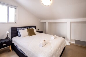 A bedroom with a bed, nightstand, lamp, and a window. - Poleg Coastal Villa • Garden by SeaNRent (Netanya)