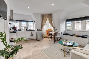 Apartment, 1 Bedroom, Kitchenette | Living area | 50-inch flat-screen TV with cable channels