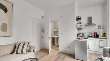 Apartment, 2 Bedrooms | Living area | 50-inch flat-screen TV with cable channels