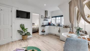 Apartment, 1 Bedroom, Kitchenette | Living area | 50-inch flat-screen TV with cable channels