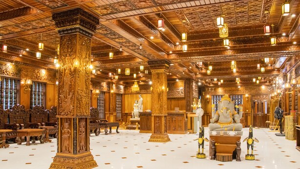 An ornate interior with high ceilings, intricate carvings, and traditional furnishings. - Puok hotel & Resort (Puok)