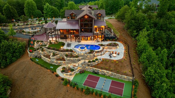 A large house with a swimming pool, tennis court, and patio areas. - Fine As Wine ~ Resort Pool, Swim-Up Bar, Pickleball, Putt-Putt & Epic Views (Sevierville)