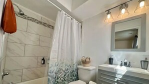 A bathroom with a bathtub, toilet, and vanity. - Private 1 bed/1bath by Downtown Columbus, Arenas, & Hospitals (Columbus)
