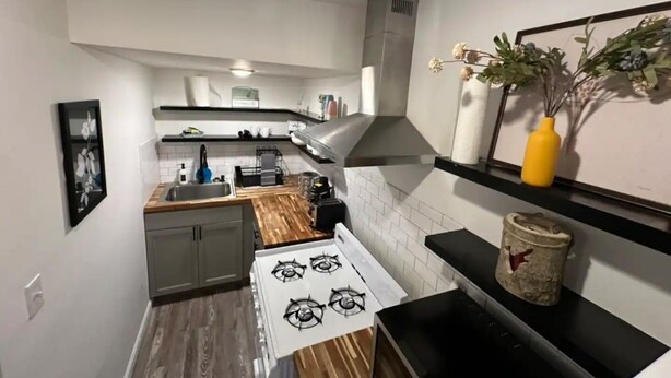 A compact kitchen with a stove, sink, and wooden countertop. - Private 1 bed/1bath by Downtown Columbus, Arenas, & Hospitals (Columbus)