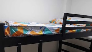 A bunk bed with a patterned bedspread and a geometric pillowcase. - HOTEL ARCI (San José de Cúcuta)