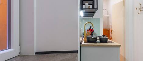 A modern kitchen with a built-in island, a sink, and a window.