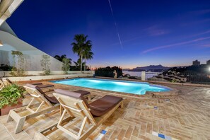 Relax by the pool surrounded by lush vegetation and breathtaking mountain views.