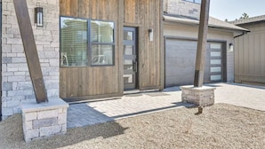 A modern house with a stone facade, wooden door, and garage. - New Modern House Built in 2024.  5 Beds and 3.5 Baths. 3020 SQFT (Flagstaff)