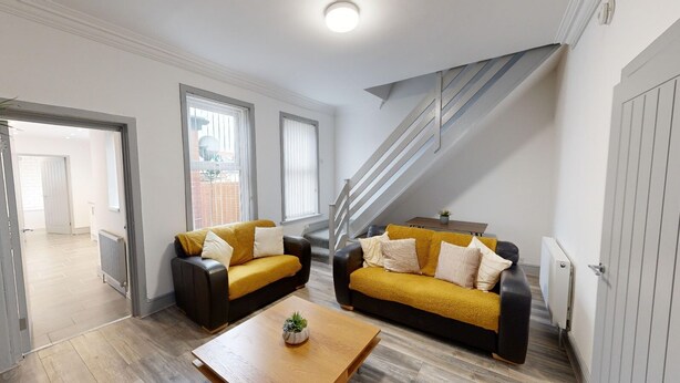 A modern living room with two sofas, a coffee table, and a staircase. - Central, Stunning 3-Bed House - Free Parking (Sunderland)