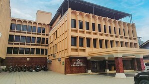 A hotel with a modern facade, multiple windows, and a covered entrance area. - Portola Arabia Hotel Banda Aceh  (Banda Aceh)